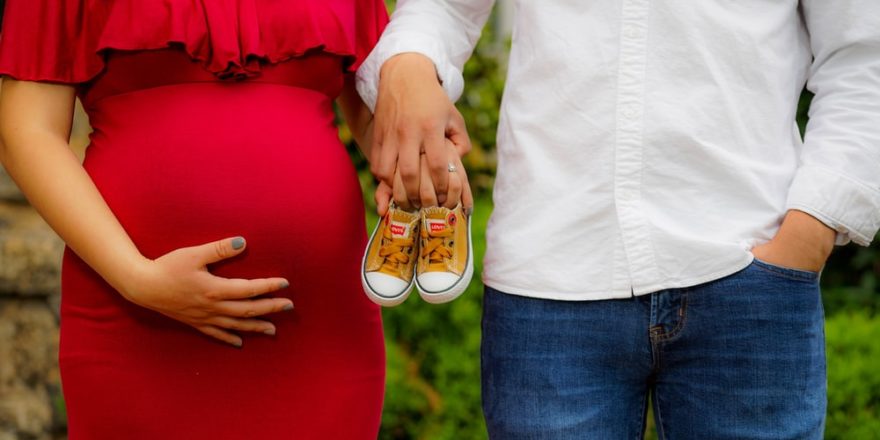 couple holding pair of brown and white low-top sneakers